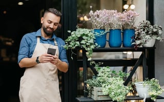 florist-front-view-guy-standing-holding-phone